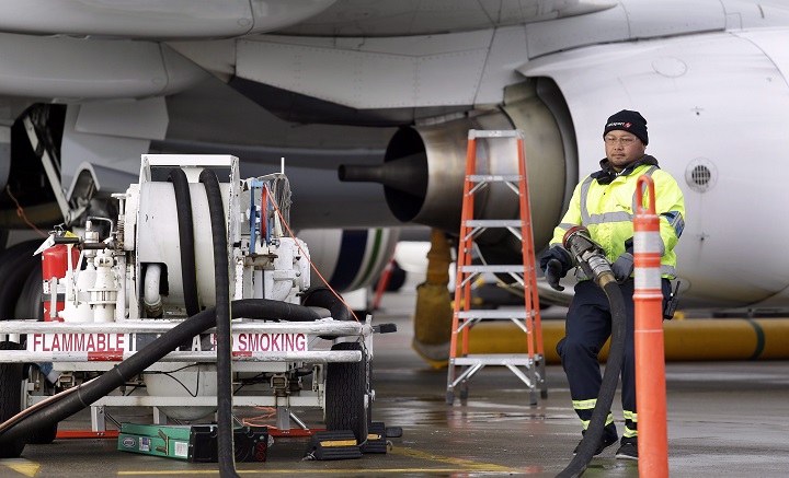 In this file photo, an airport worker stows gear after pumping fuel into a plane. d Swissport Canada workers in charge of refuelling planes at Montreal's Trudeau and Mirabel airports are voting on a new contract offer.  Friday, Dec. 27, 2019.