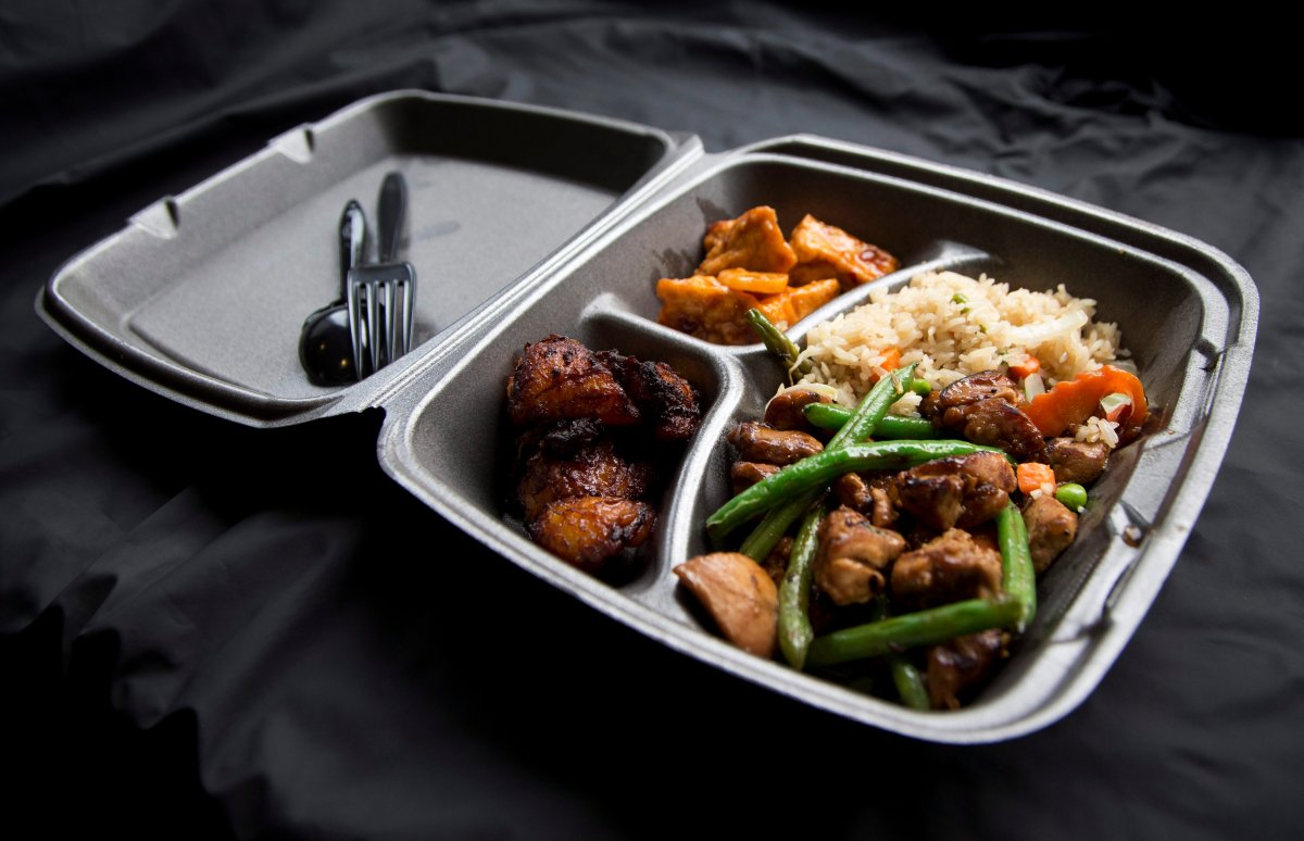 A styrofoam container with takeout food.