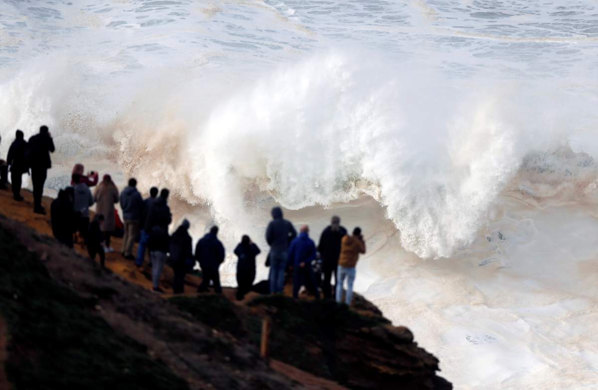 People gather to watch big waves at Praia do Norte in Nazare, Portugal December 22, 2019. REUTERS/Rafael Marchante