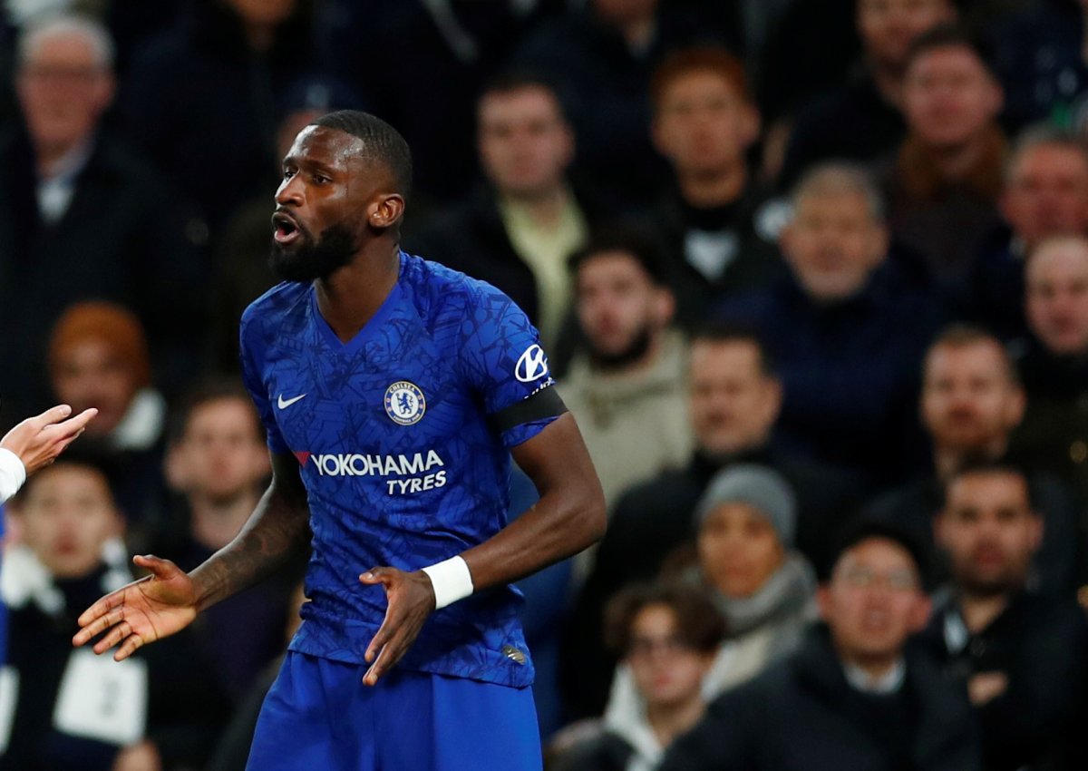 Chelsea's Antonio Rudiger reacts as Tottenham fans look on.  