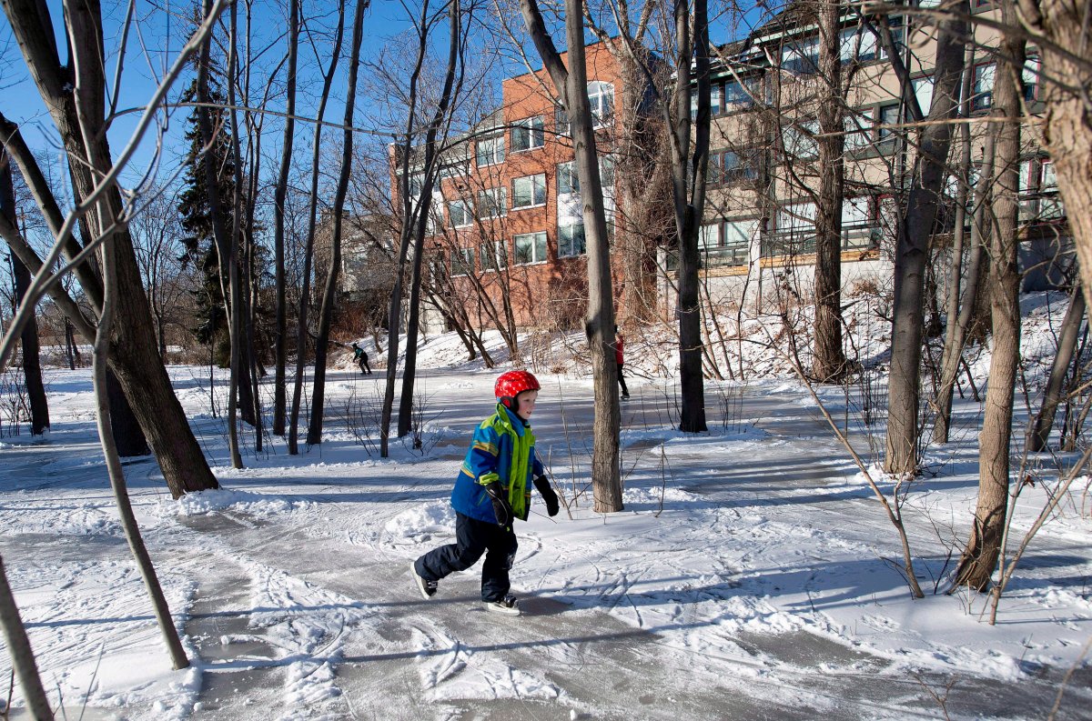 Liam R., 8, skates among the trees in Ottawa's Central Park, on Christmas Day, Tuesday, Dec. 25, 2018. Neighbours shovelled snow off the frozen surface to create a skating path and ice rink after the park was saturated by rainfall and froze over.