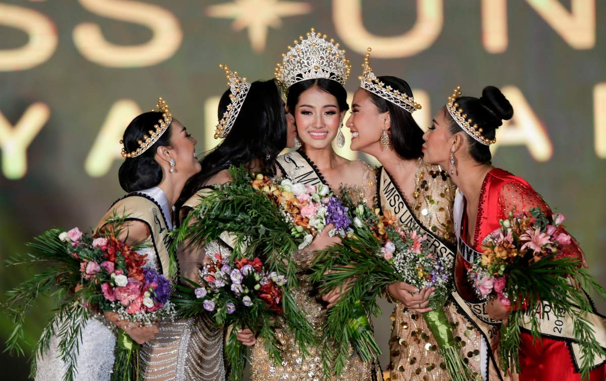 Contestants kiss Miss Universe Myanmar 2019 Swe Zin Htet (centre) as they celebrate during Miss Universe Myanmar 2019 pageant contest in Yangon, Myanmar, May 31, 2019.