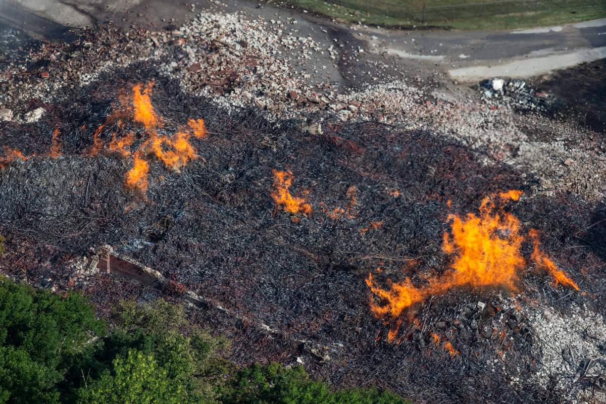 In a Wednesday, July 3, 2019 file photo, flames and smoke rise from a bourbon warehouse fire at a Jim Beam distillery in Woodford County, Ky.