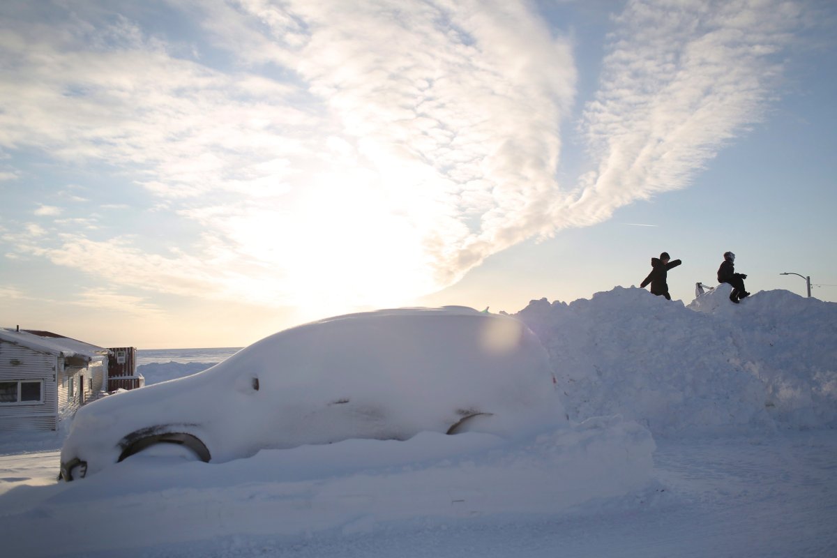In this Feb. 14, 2019, photo, children play on a snow berm near the shores of the Bering Sea in Nome, Alaska. 