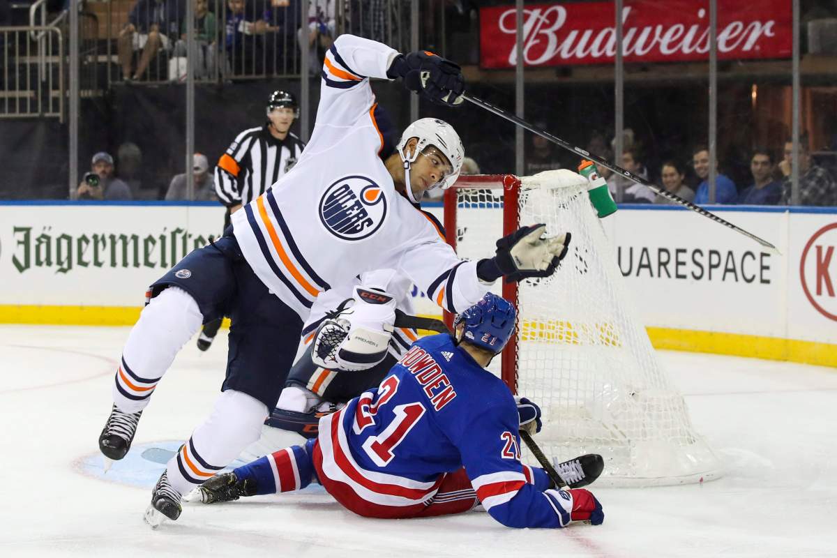 Edmonton Oilers defenseman Darnell Nurse trips over New York Rangers center Brett Howden (21) during the second period of an NHL hockey game, Saturday, Oct. 12, 2019, at Madison Square Garden in New York. (AP Photo/Mary Altaffer).
