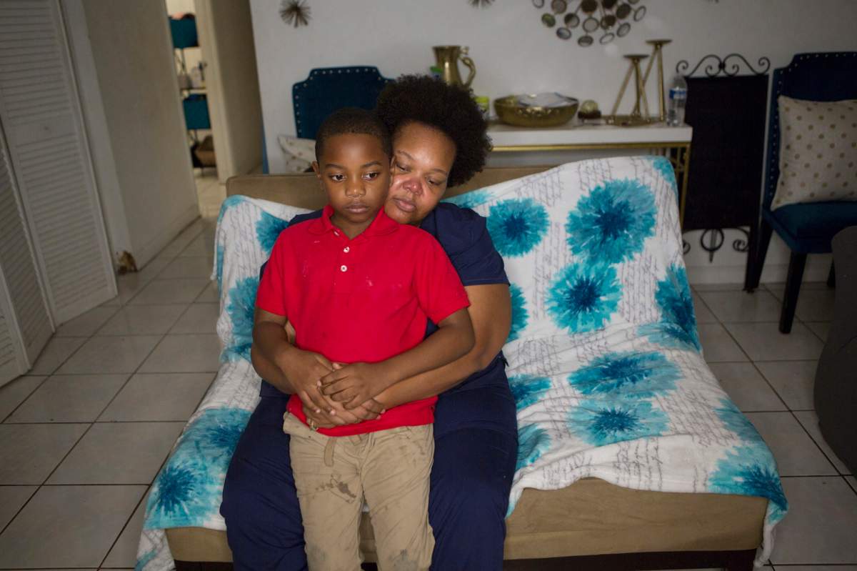 In this Nov. 4, 2019 photo, Kina Phillips holds her 5-year-old grandson Jamal Tillman, at their home in South Bay, Fla.