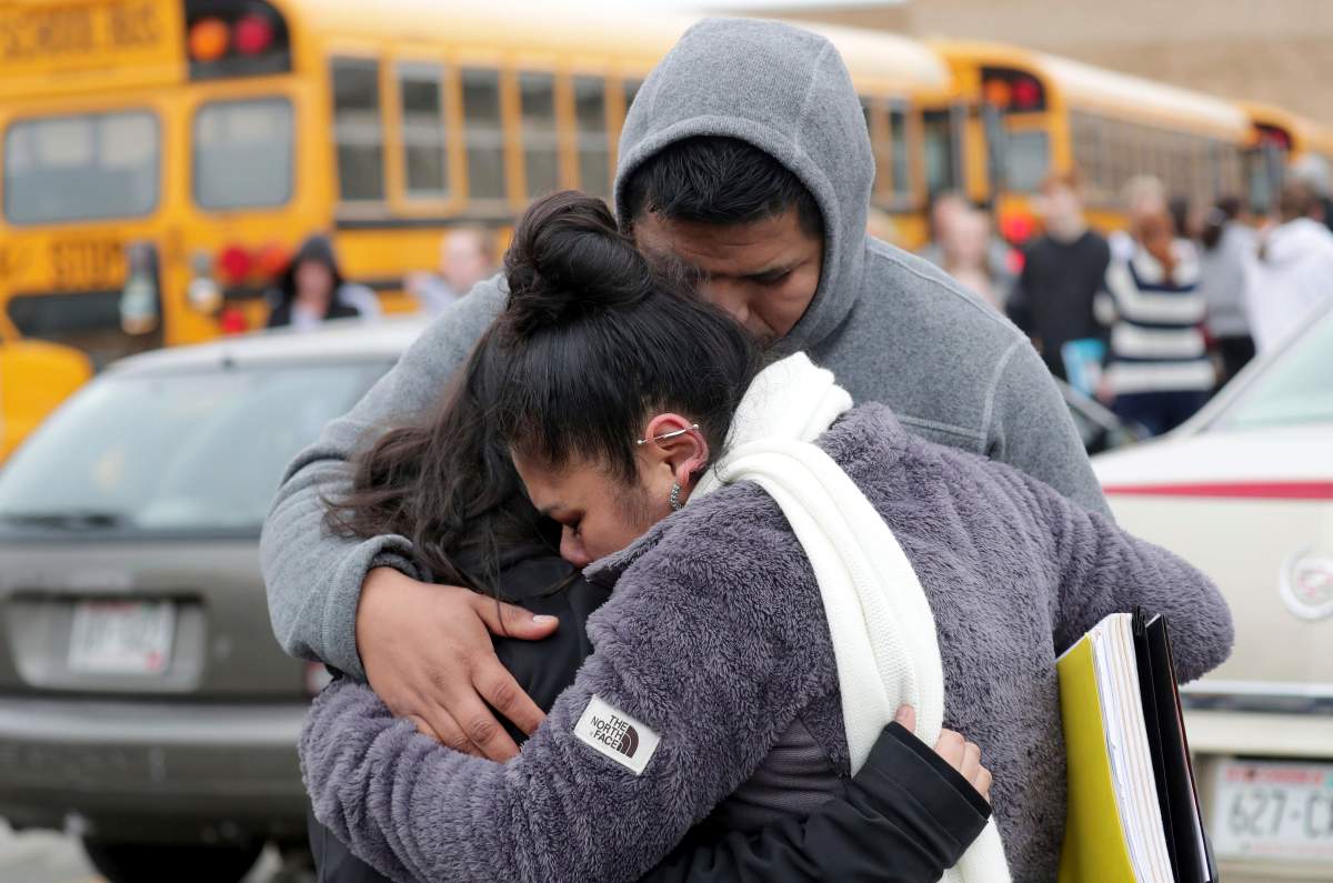Becky Galvan, center, consoles her daughter, Ashley Galvan, a 15-year-old sophomore, with her father Jose Chavez outside Waukesha South High School in Waukesha on Dec. 2, 2019.