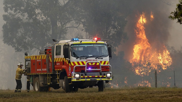 Firefighters work to contain a fire near Stanford Merthyr, west of Newcastle, New South Wales, Australia, Dec. 3, 2019.