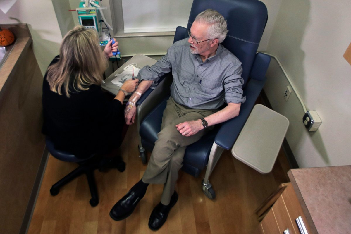 Charles Flagg, who is stricken with Alzheimer's disease, sits for an infusion while participating in a study on the drug Aducanumab at Butler Hospital in Providence, R.I.