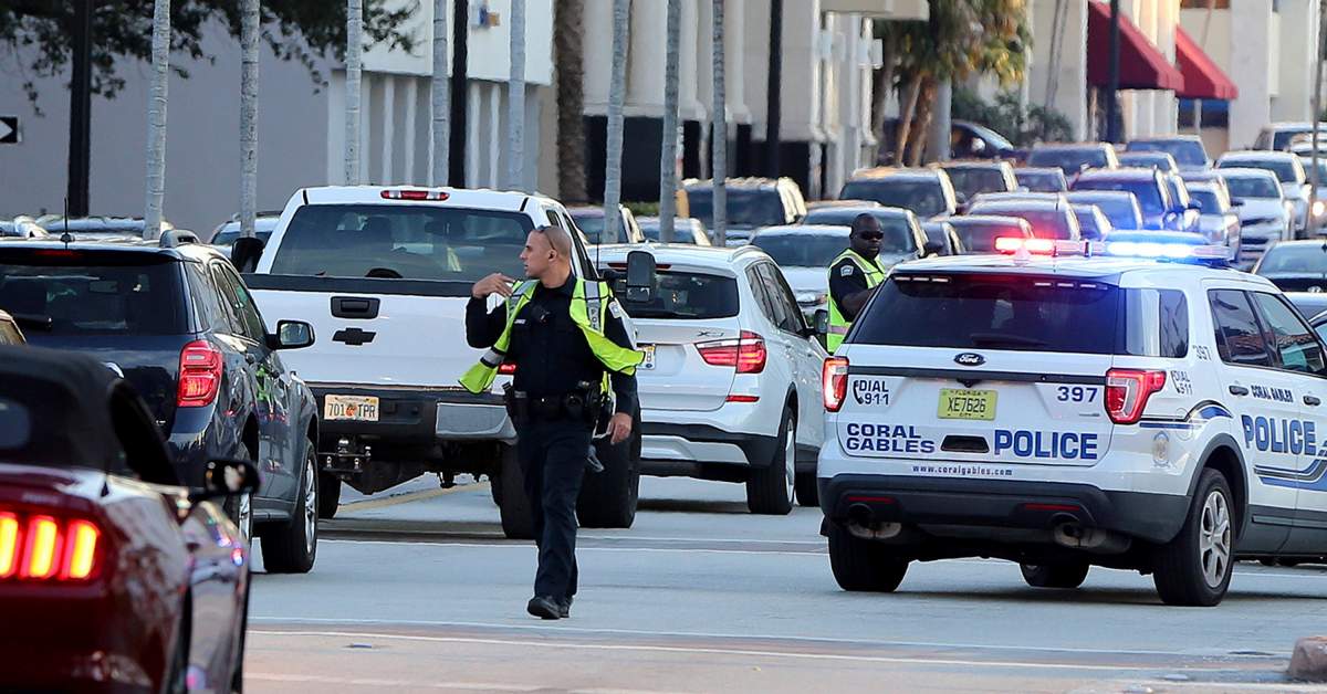 Coral Gables police officers direct traffic after a robbery at a jewelry store in Coral Gables, Fla., Thursday, Dec. 5, 2019. The FBI said four people, including a UPS driver, were killed after robbers stole the driver’s truck and led police on a chase that ended in gunfire at a busy Florida intersection during rush hour. (Pedro Portal/Miami Herald via AP)
