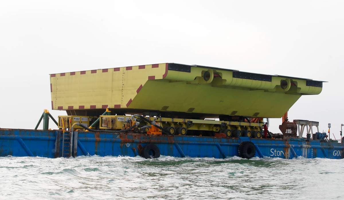 A yellow barrier, part of a plan to protect the city of Venice from flooding, floats on a barge, in Venice, Italy, Friday, Nov. 29, 2019.