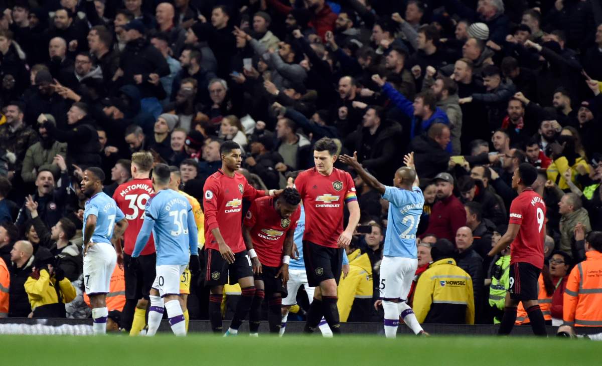 Players react to items thrown by Manchester City fans during the English Premier League soccer match between Manchester City and Manchester United at Etihad stadium in Manchester, England, Saturday, Dec. 7, 2019. 