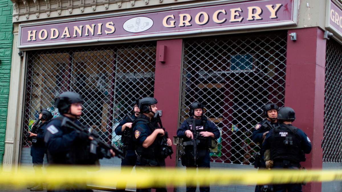 Law enforcement guard near the scene following a shooting, Dec. 10, 2019, in Jersey City, N.J.