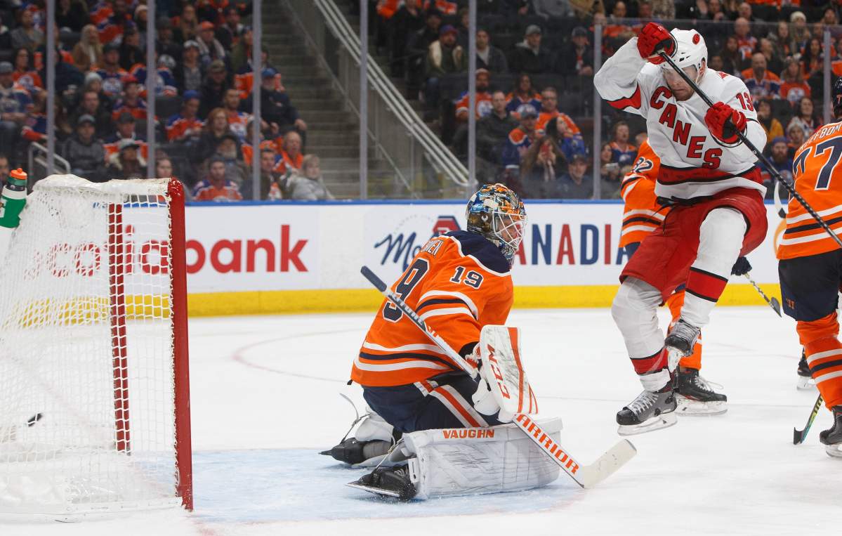 Carolina Hurricanes' Warren Foegele jumps as the puck goes past Edmonton Oilers goalie Mikko Koskinen (19) during third period NHL action in Edmonton, Alta., on Tuesday December 10, 2019. THE CANADIAN PRESS/Jason Franson.