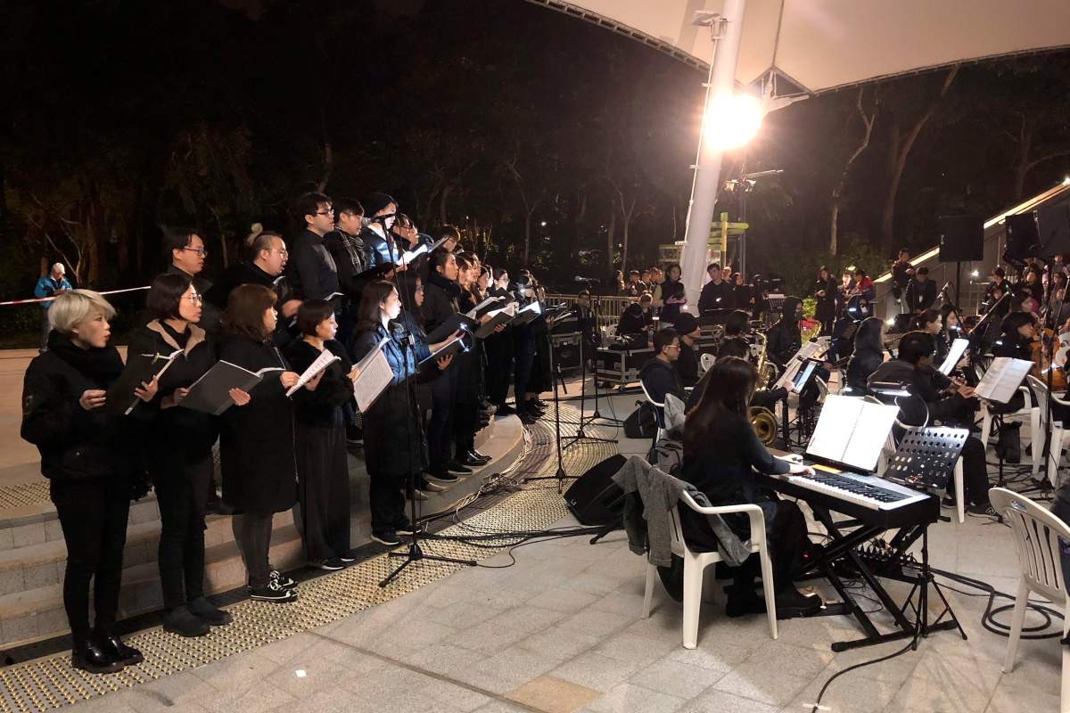 In this Dec. 10, 2019 photo, a theatre troupe performs Les Miserables in at an outdoor event space in Hong Kong.