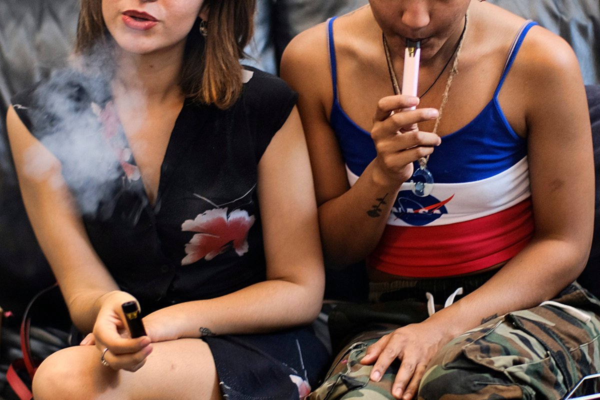 FILE - In this Saturday, June 8, 2019, file photo, two women smoke cannabis vape pens at a party in Los Angeles.