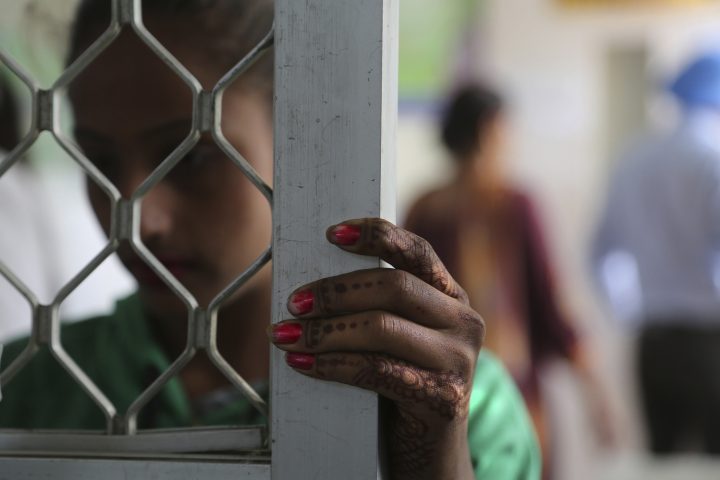 In this Thursday, Oct. 31, 2019, photo, a recovering tramadol addict waits for her medication at a de-addiction center in Kapurthala, in the northern Indian state of Punjab.