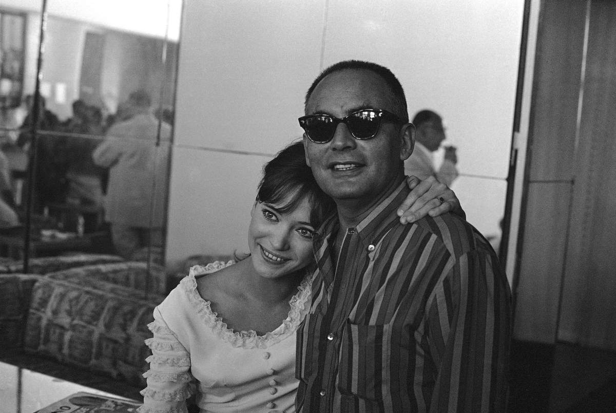 In this Aug. 29 1965 photo, French actress Anna Karina embraces Italian producer Dino De Laurentiis at the end of a press conference on the Venice Lido on the French entry in the International Film Festival.