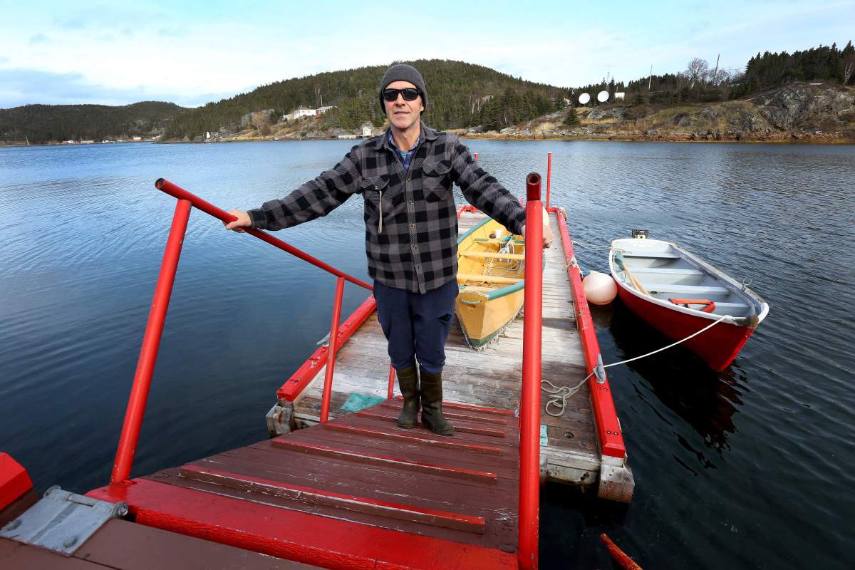 Mike Parsons stands on his dock at Little Bay Islands, N.L. on Friday, November 15, 2019. Parsons doesn’t plan on leaving the community, and will live there, off the grid, with his wife. Little Bay Islanders are saying goodbye as the Newfoundland and Labrador town resettles, but some are eyeing a return. THE CANADIAN PRESS/Paul Daly