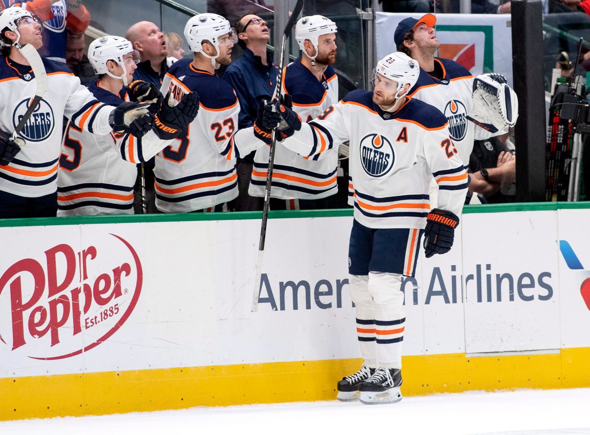 Edmonton Oilers center Leon Draisaitl (29) is congratulated by teammates on the bench after scoring a goal against the Dallas Stars in the first period of an NHL hockey game, Monday, Dec. 16, 2019, in Dallas. (AP Photo/Jeffrey McWhorter).