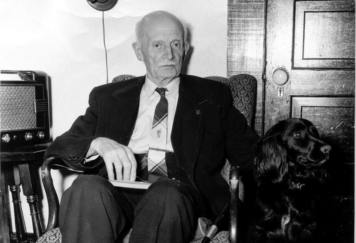 Former federal and provincial politician Alan Webster Neill sits with his dog in a photo from 1955 at the age of 87. The Alberni School District in B.C. is preparing a public consultation for the renaming of A.W. Neill Elementary School, over Neill's support of anti-Chinese laws in the legislature and his approval of Indigenous residential schools. 