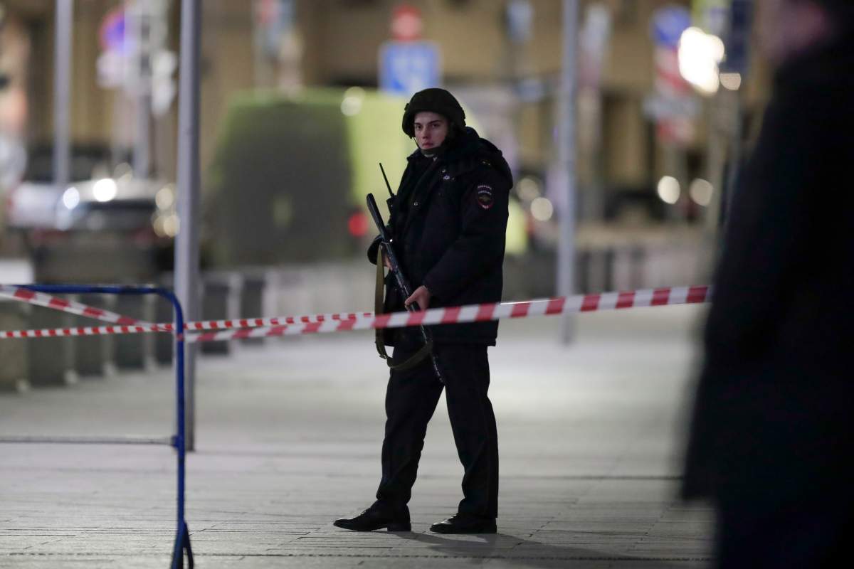A Russian police officer secures the area near the building of the Federal Security Service (FSB, Soviet KGB successor) in the background in Moscow, Russia, Thursday, Dec. 19, 2019. (AP Photo/Pavel Golovkin)
