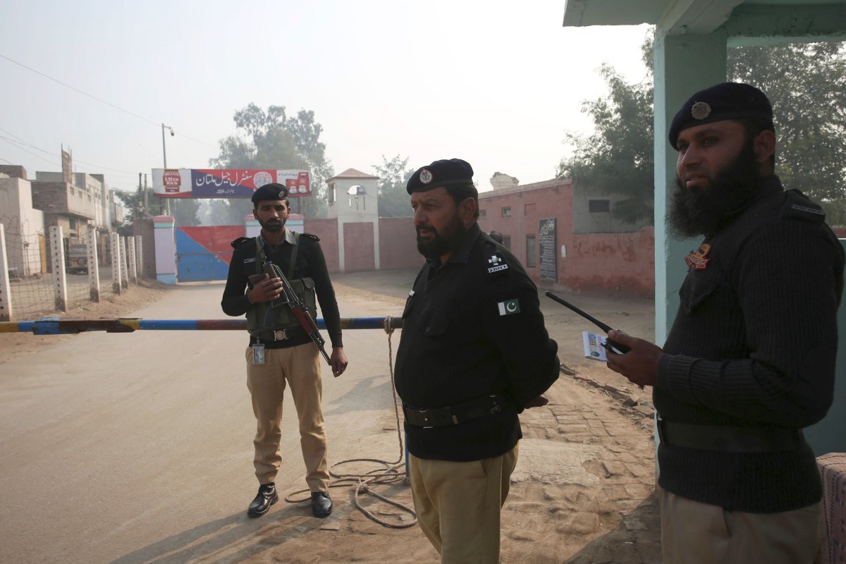 Pakistani police officers stand guard outside Multan jail after a court's decision for a professor facing blasphemy case, in Multan, Pakistan, Saturday, Dec. 21, 2019.