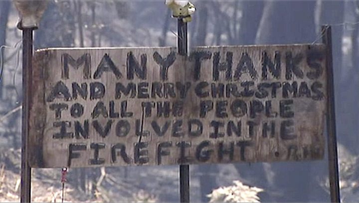 In this image made from video, a sign offers thanks and a Merry Christmas in a destroyed residential area by wildfire, Dec. 23, 2019, in the Blue Mountains, New South Wales, Australia.
