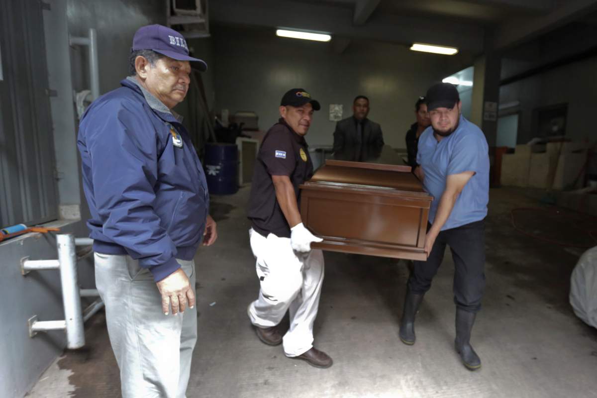 A coffin of a man who died during a riot at the El Porvenir prison is carried out of a morgue in Tegucigalpa, Honduras, Dec. 23, 2019.