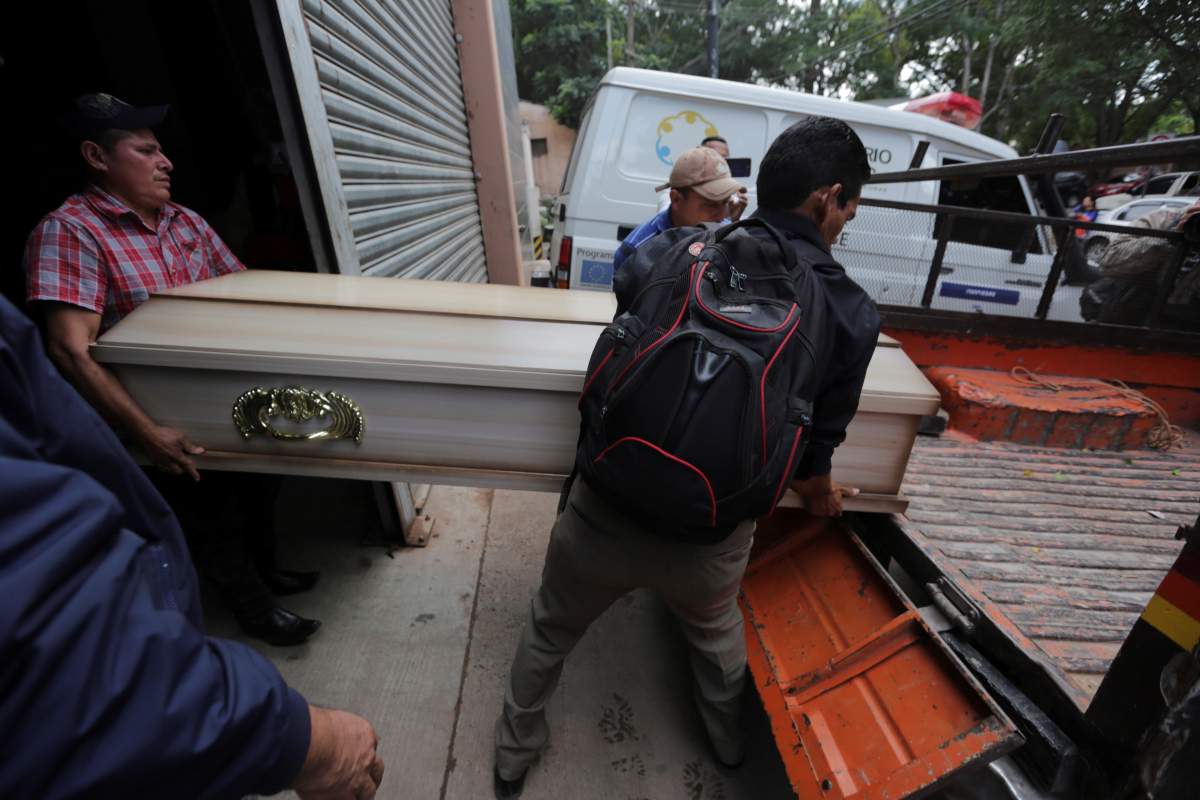 Family members carry the coffin of a man who died during a riot at the El Porvenir prison in Tegucigalpa, Honduras, Dec. 23, 2019.