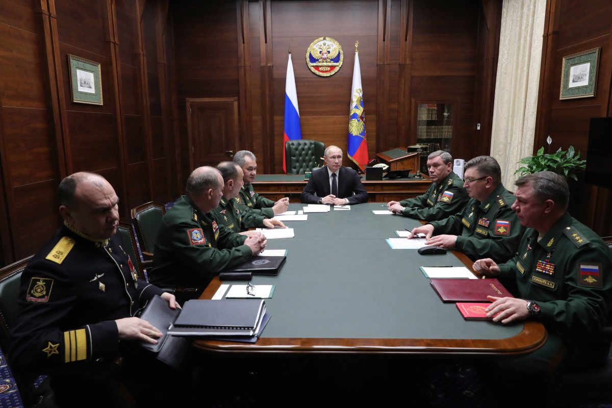 Russian President Vladimir Putin, center, leads a meeting with top military officers after an annual meeting with top military officials in the National Defense Control Center in Moscow, Russia, Tuesday, Dec. 24, 2019. 