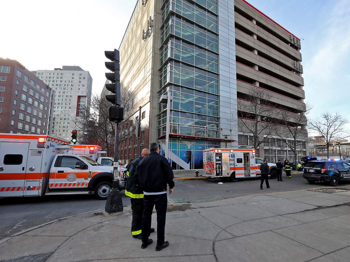 Emergency personnel at the scene of an incident at the Renaissance Park Garage where an adult and two children fell from the garage and were found dead on a sidewalk near the Boston parking garage, Dec. 25, 2019.