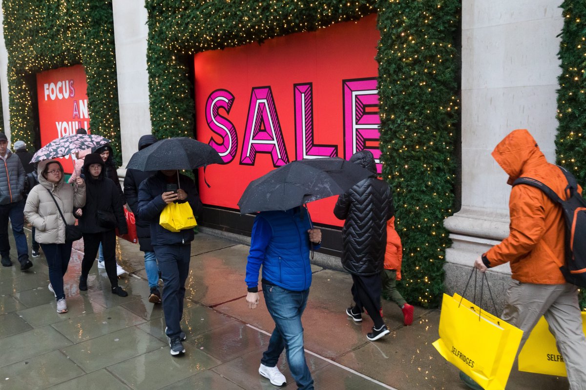 Shoppers visiting the Boxing Day sales during wet and rainy weather in Oxford Street, London, Britain, Dec. 26, 2019.