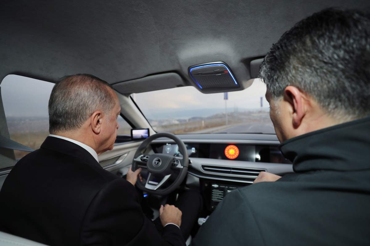 Turkish President Recep Tayyip Erdogan drives a prototype of a domestically produced electric car, in Gebze, Turkey, Friday, Dec. 27, 2019.