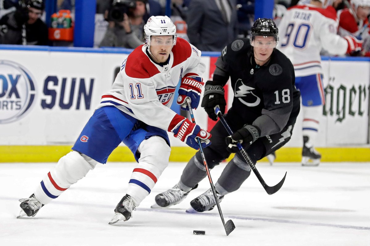 Montreal Canadiens right winger Brendan Gallagher (11) carries the puck past Tampa Bay Lightning left winger Ondrej Palat (18) during the third period of an NHL hockey game Saturday, Dec. 28, 2019, in Tampa, Fla.