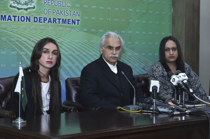 Dr. Zafar Mirza, center, Special Assistant to the Prime Minister on National Health, addresses a news conference with members of the Pakistani transgender community in Islamabad, Pakistan, Tuesday, Dec. 31, 2019. 