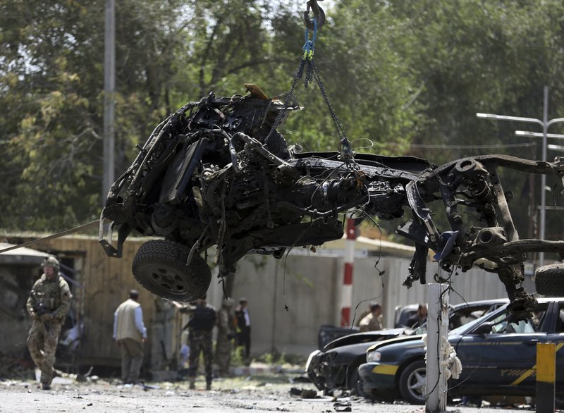 File- in this Thursday, Sept. 5, 2019. Photo, Resolute Support (RS) forces remove a destroyed vehicle after a car bomb explosion in Kabul, Afghanistan. An American service member was killed in action on Monday in Afghanistan the U.S. military said in a statement without providing more details. 