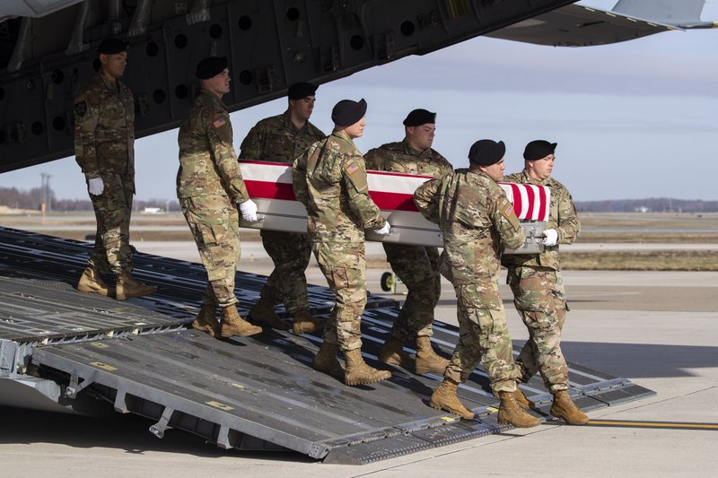 FILE - In this Dec. 25, 2019, file photo, an Army carry team moves a transfer case containing the remains of U.S. Army Sgt. 1st Class Michael Goble, at Dover Air Force Base, Del.. Goble, a U.S. Special Forces soldier who died in Afghanistan this week, was seizing a Taliban weapons cache when he was killed, the U.S. military said Friday. 