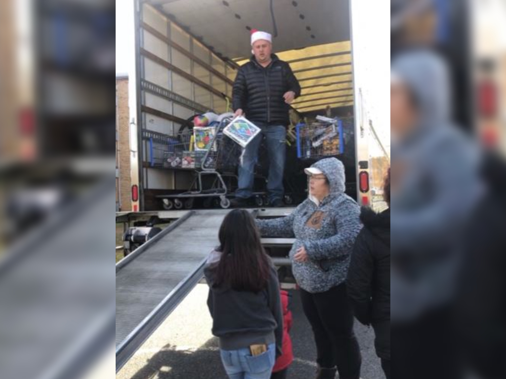 Adam Armstrong returned to the Harrisonburg, Va., apartment complex where he grew up poor to dole out $12,000 worth of toys.