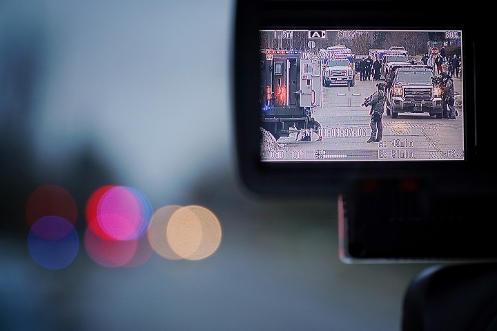 York Regional Police officers surround a home in Richmond Hill on Friday. Police said they were attempting to negotiate with a suspect inside.