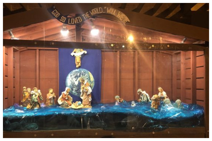 A Christmas nativity scene depicts Jesus, Mary, Joseph and their visitors in knee-deep water at St. Susanna Parish in Dedham, Mass.