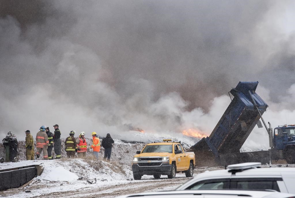 A spokesman for Emergency Measures says sand has been effective in suffocating portions of a tire fire in Minto, N.B., but a water advisory is now in place. Tires burn behind TRACC Tire Recycling in Minto, N.B., about 40 minutes northeast of Fredericton, Sunday, Dec. 22, 2019.