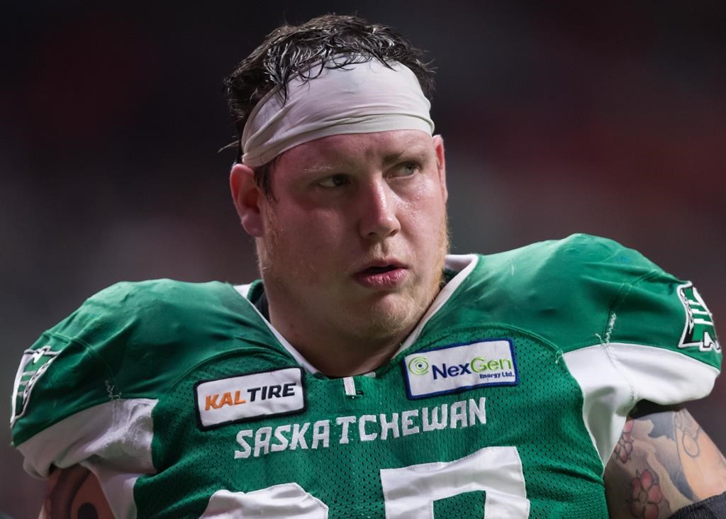 Saskatchewan Roughriders' Dan Clark leaves the game after being injured during the first half of a CFL football game against the B.C. Lions in Vancouver, on Friday October 18, 2019. The Roughriders have signed Canadian centre Clark to a two-year contract extension. 