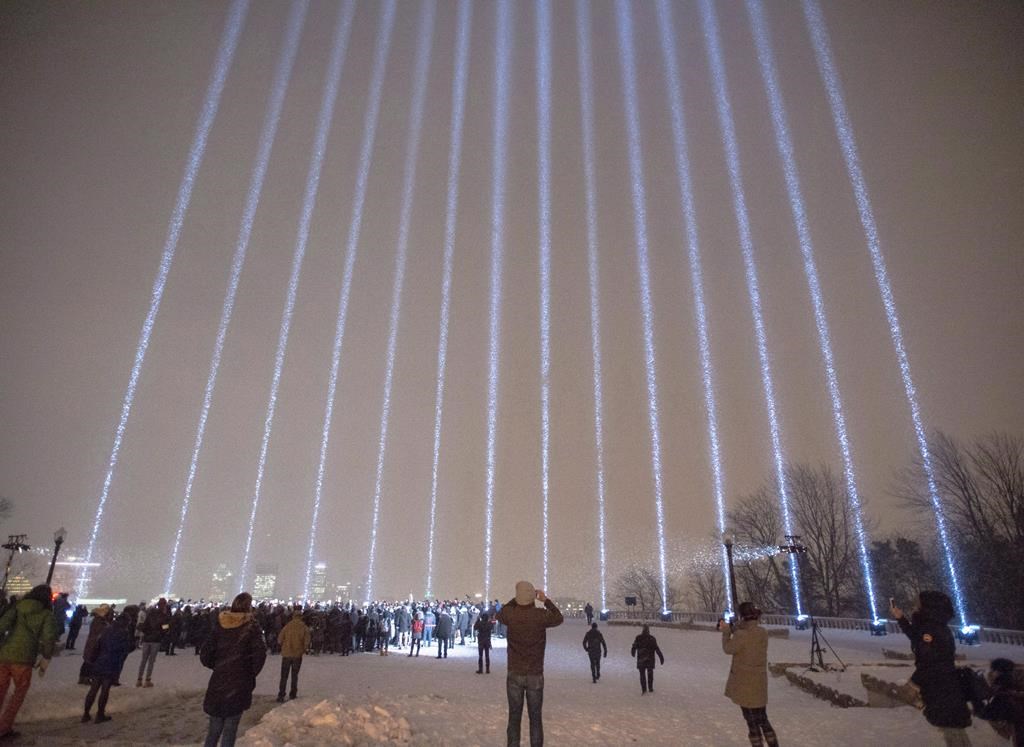 Fourteen lights shine skyward at a vigil honouring the victims of the 1989 Ecole Polytechnique attack, Thursday, December 6, 2018 in Montreal. Several events are planned across the country today to mark the grim 30th anniversary of the Montreal Massacre. On the evening of Dec. 6, 1989, a gunman entered Montreal's Ecole polytechnique, killing 14 women in an anti-feminist mass slaying before taking his own life.THE CANADIAN PRESS/Ryan Remiorz.