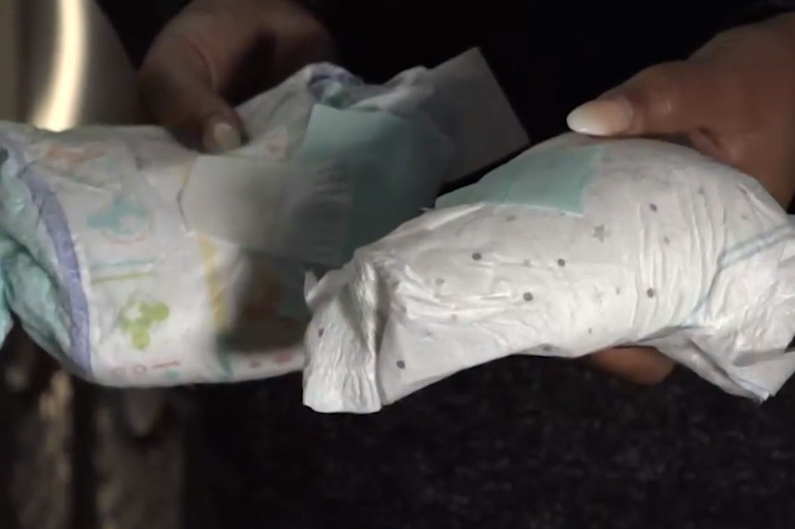 A Missouri woman shows off diapers after leaving several soiled ones for a porch pirate.