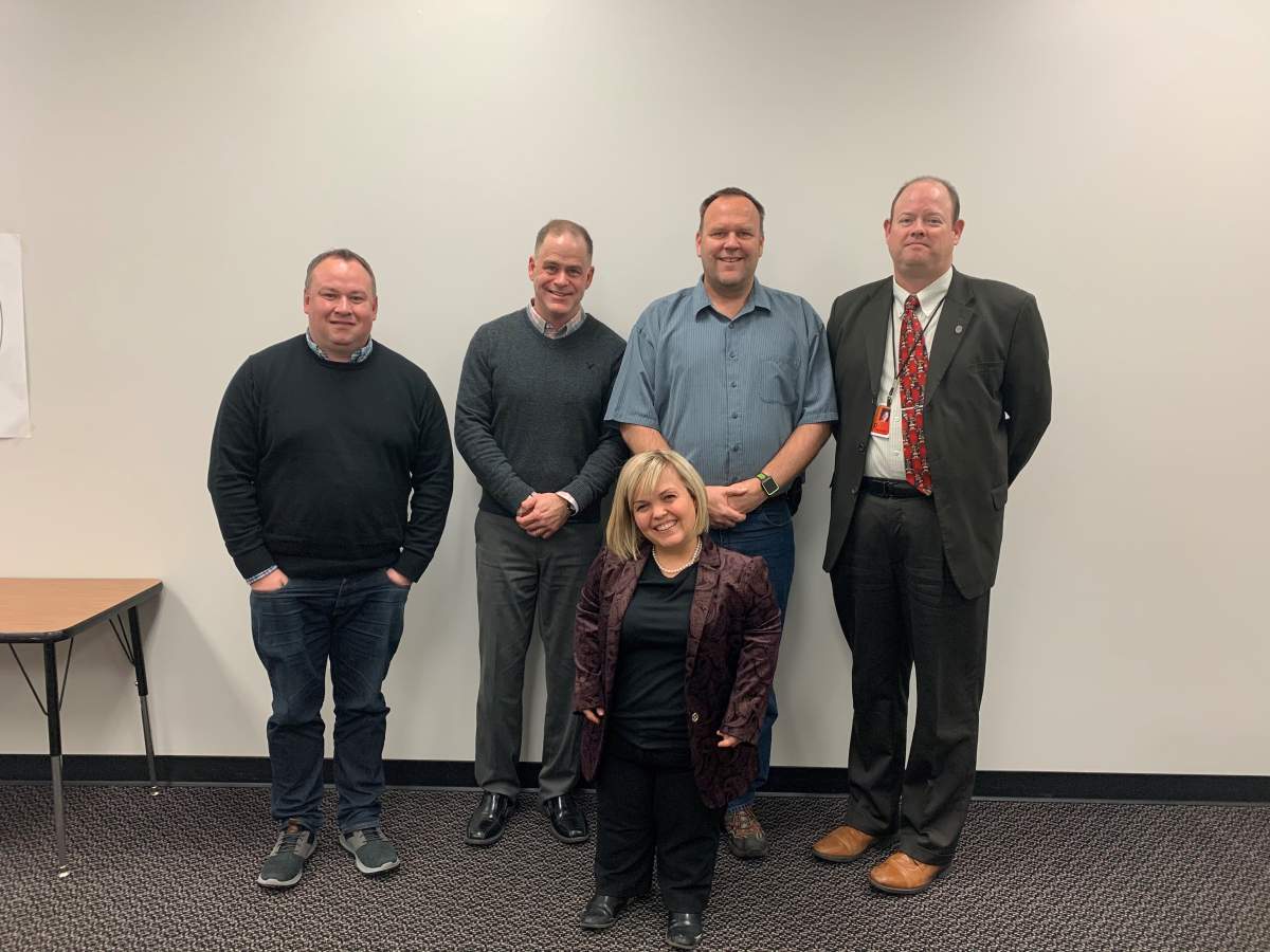 Samantha Rayburn-Trubyk (front) in Dickinson, N.D., with (from left) her husband Ryan Trubyk, school board president Brent Seams, Daren Stenvold (father of a child born with dwarfism), and superintendent Dr. Hocker.