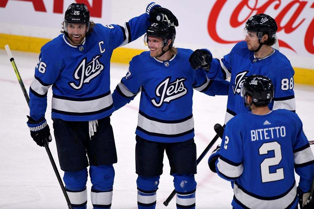 Winnipeg Jets' Nikolaj Ehlers (27) celebrates his goal against the Philadelphia Flyers with teammates Blake Wheeler (26), Nathan Beaulieu (88) and Anthony Bitetto (2) during first-period NHL action in Winnipeg on Sunday, Dec. 15, 2019.