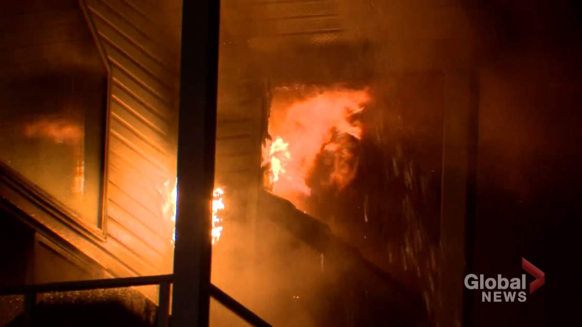 Flames are seen coming from a condo building in Calgary on Friday evening.
