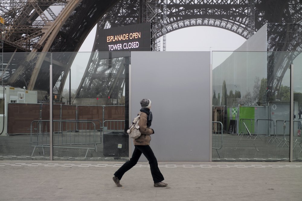 A woman walks past the closed Eiffel Tower in Paris, Thursday, Dec. 5, 2019. The Eiffel Tower shut down Thursday, France’s vaunted high-speed trains stood still and teachers walked off the job as unions launched nationwide strikes and protests over the government’s plan to overhaul the retirement system.