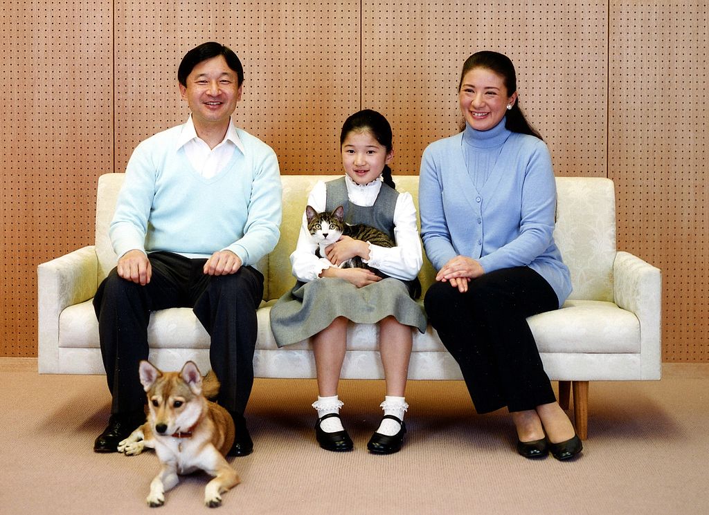 In this photo taken on Dec. 2, 2010 and released by the Imperial Household Agency of Japan, Crown Prince Naruhito and Crown Princess Masako smile as they look on their daughter Princess Aiko holding her cat with her dog Yuri.